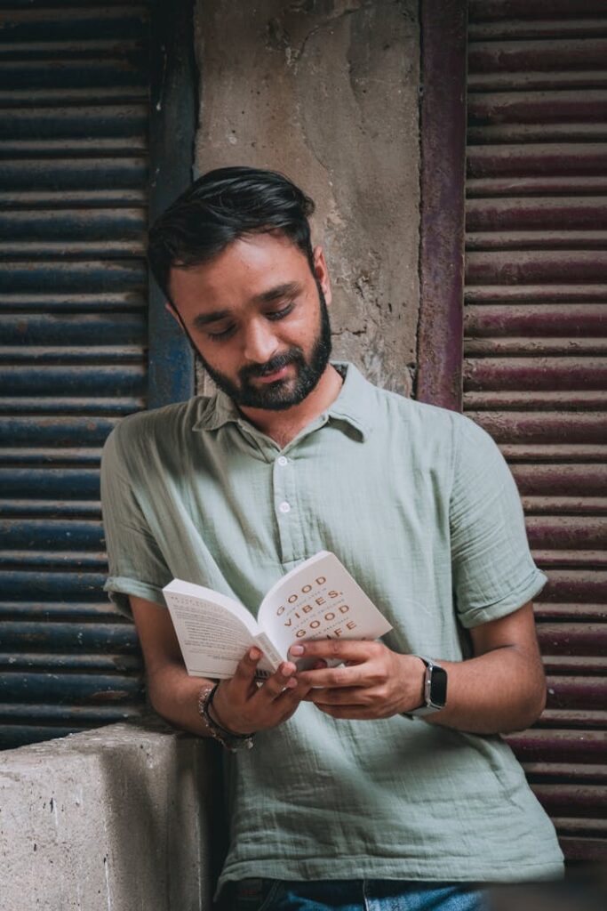 Man Reading a Book About Self-improvement